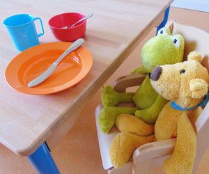 Zwei Kuscheltiere beim Mittagessen in unserer Kita